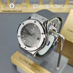 Super Clone Watches – Hublot Classic Fusion 565.NX.7071.RX Experience the precision and craftsmanship of our Hublot Classic Fusion 38MM 565.NX.7071.RX Super Clone Watch — a true 1:1 masterpiece. Featuring a sleek titanium case, elegant grey sunburst dial, and durable rubber strap, this timepiece perfectly balances luxury and performance. The transparent case back reveals the refined automatic movement, showcasing the art of mechanical precision. Each Clone Watches is meticulously engineered to mirror the authentic Hublot Classic Fusion in every detail — from its brushed bezel to the engraved crown. With a 9.4mm slim profile and 81g lightweight design, it offers both comfort and sophistication for everyday wear. Shop Clone Watches for exceptional quality, timeless aesthetics, and unbeatable value — a perfect blend of Swiss-inspired craftsmanship and modern innovation.
